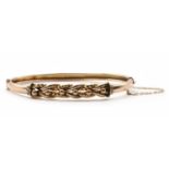 A gold hollow oval hinged bangle,