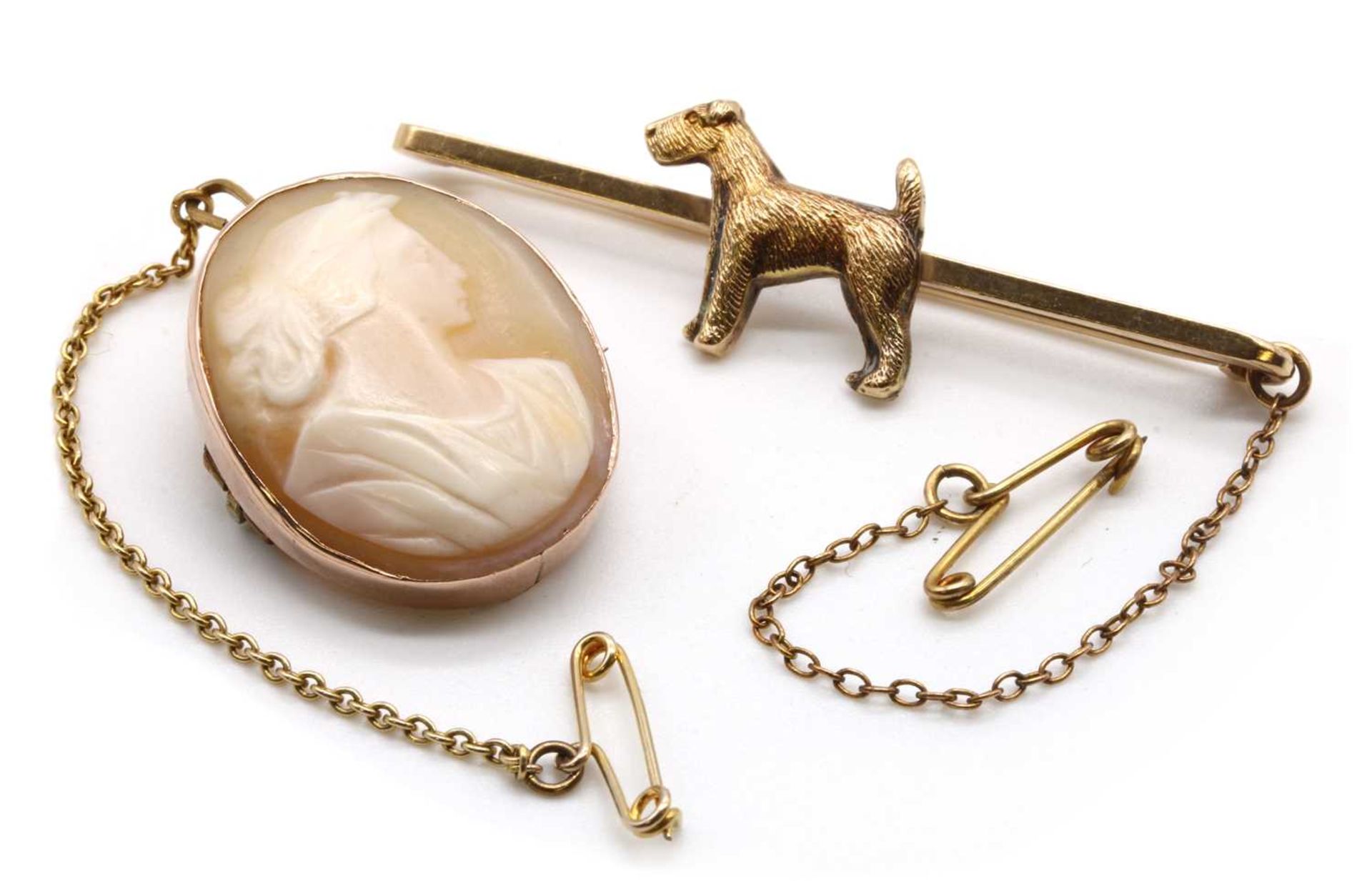 A gold dog bar brooch,