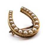 A gold split pearl horseshoe brooch,