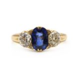 A gold sapphire and diamond three stone ring,