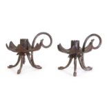 A pair of unusual iron chambersticks,