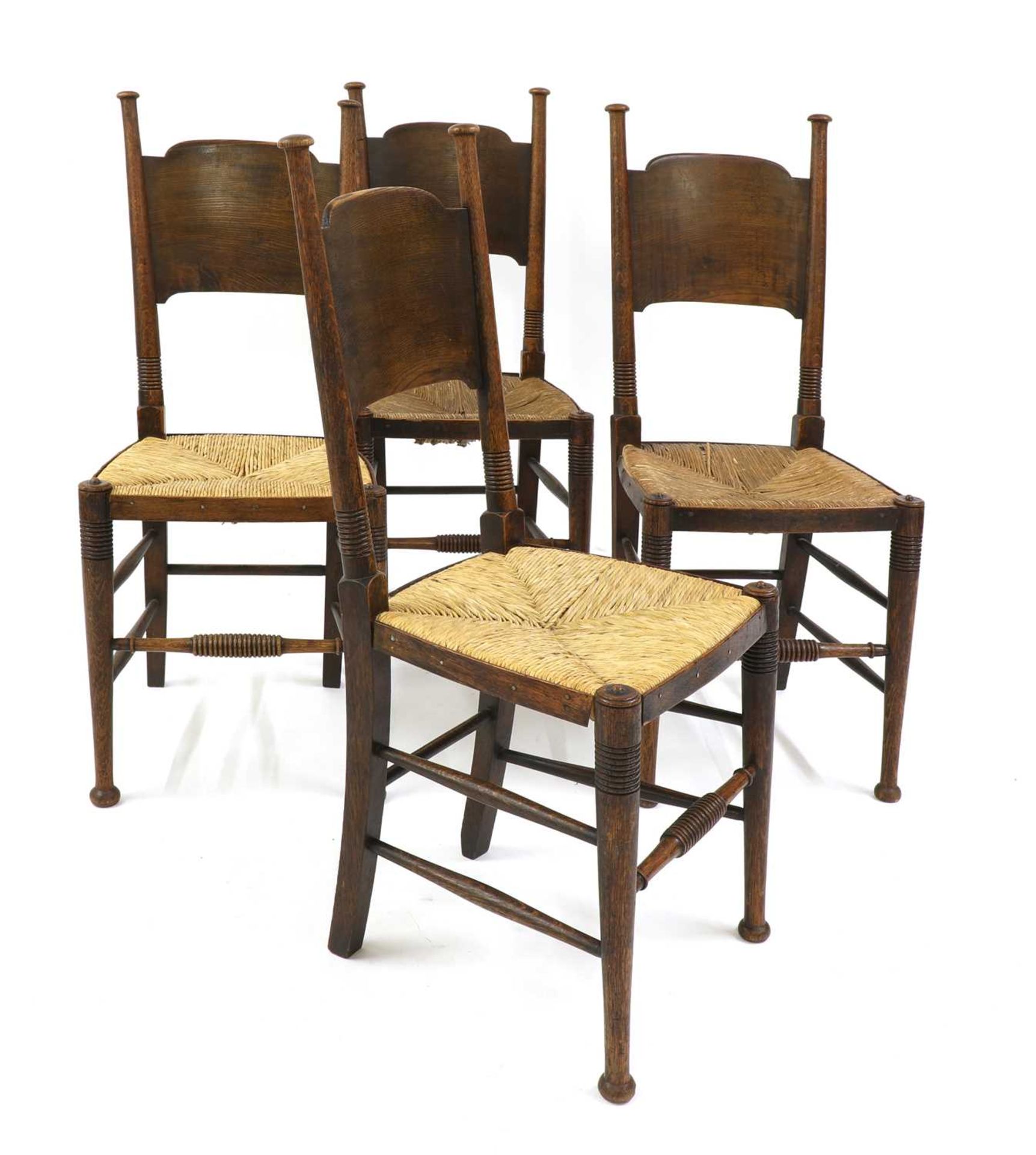 A set of four oak and rush-seated chairs,