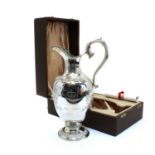 A commemorative silver claret jug,