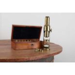 A lacquered brass 'Large Improved Compound' monocular 'drum' microscope,