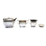 A silver three piece tea service