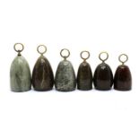 A group of six Victorian serpentine marble doorstops,