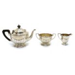 A silver three piece tea service