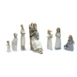 A collection of seven Nao and Lladro figurines,