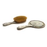 A silver-mounted mirror and hair brush,