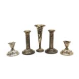 A collection of silver candlesticks