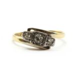 A gold three stone diamond ring,