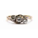 A gold three stone diamond ring,