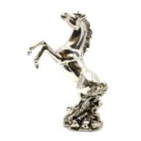 A silver plated model of a horse,