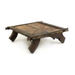 A teak and wrought iron mounted elephant table,