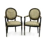 A pair of ebonised and parcel gilt Louis XVI style fauteuils