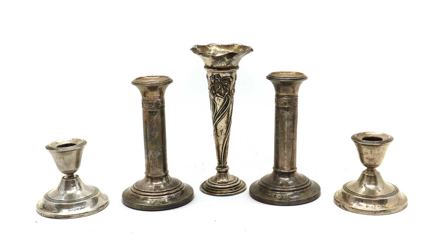 A collection of silver candlesticks