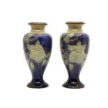 A pair of Royal Doulton stoneware Roses pattern vases,