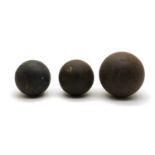 A group of three cannonballs,