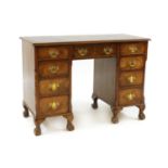 A Queen Anne style walnut twin-pedestal desk,