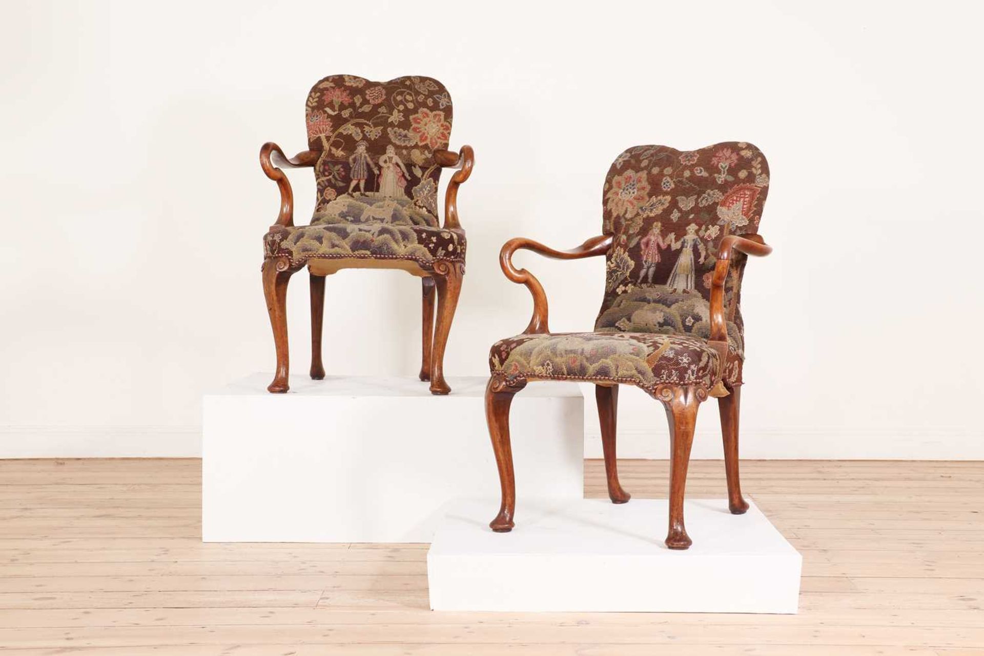 A pair of Queen Anne-style walnut armchairs,