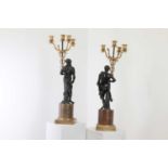 A pair of gilt and patinated bronze candelabra,