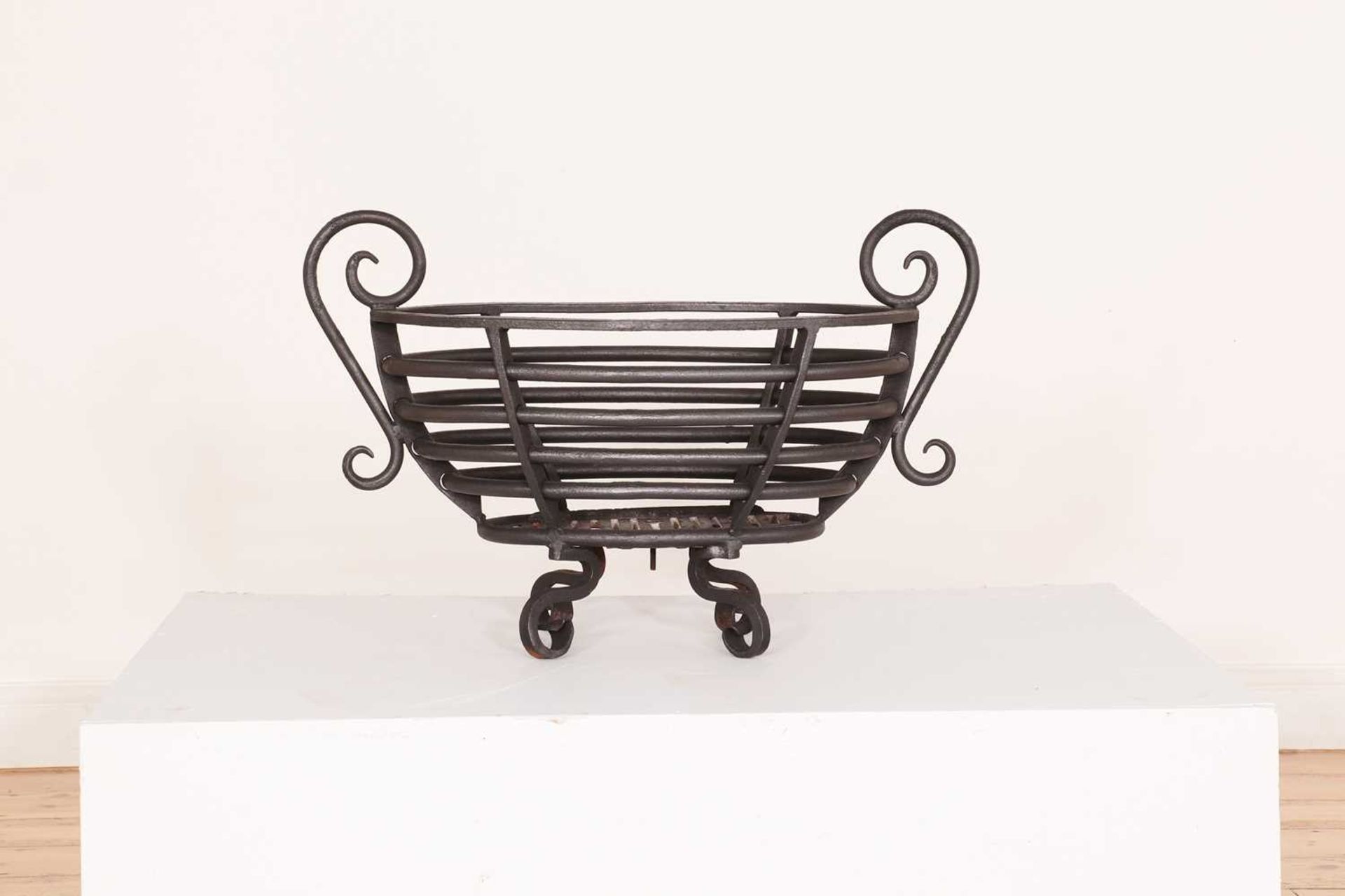 A Regency-style steel fire basket,