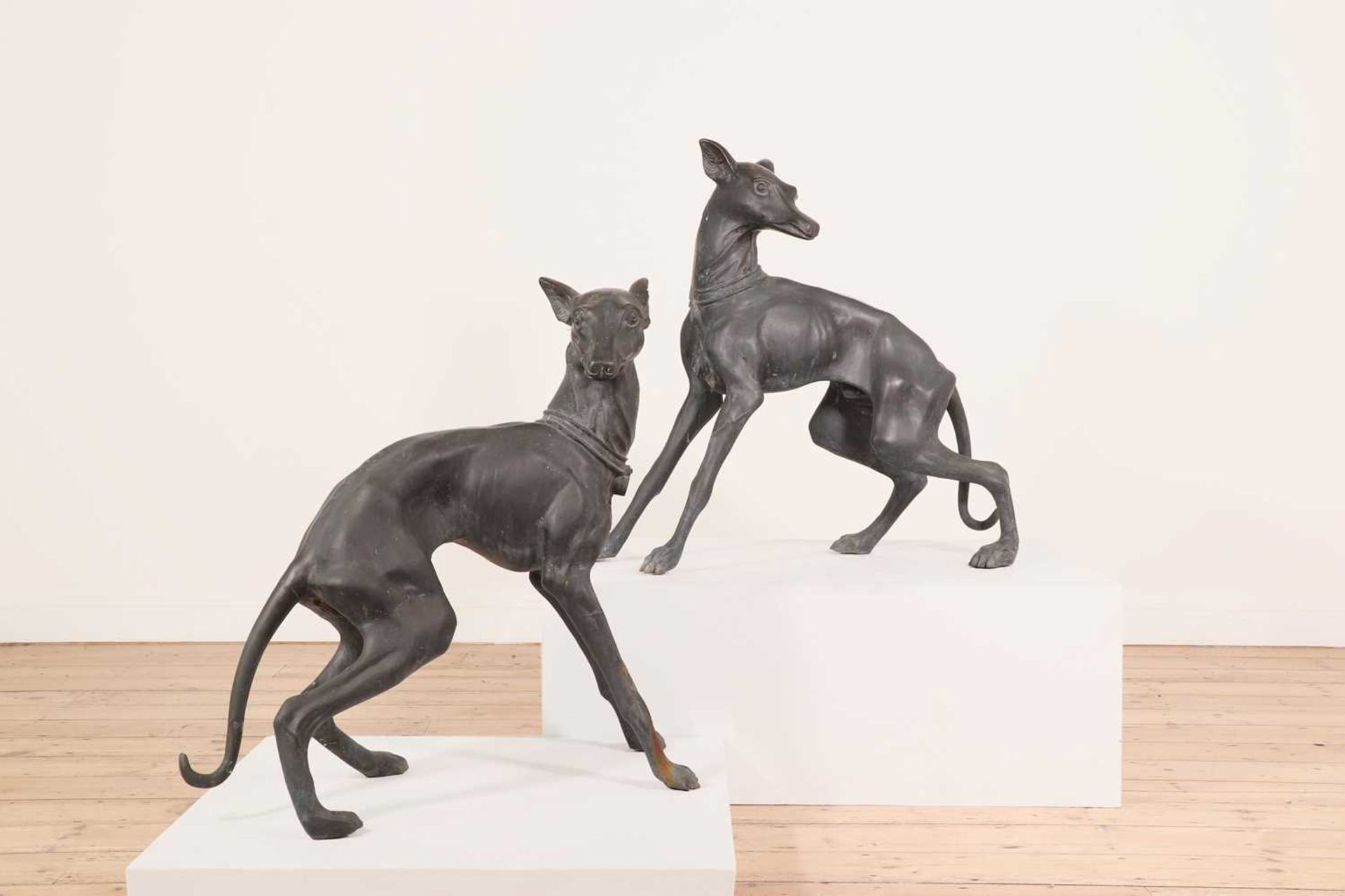 A pair of large bronze figures of whippets,