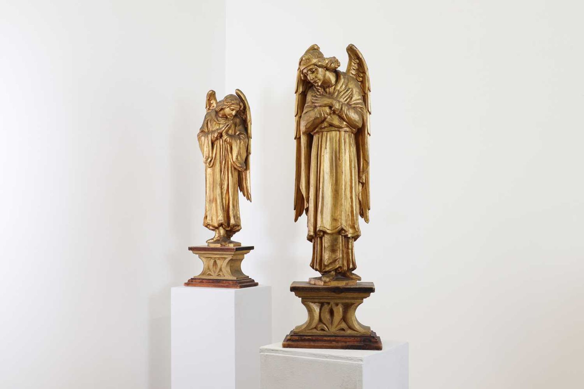 A pair of carved giltwood figures of angels,