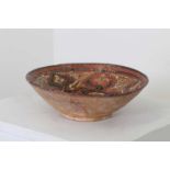 A Persian terracotta glazed bowl,