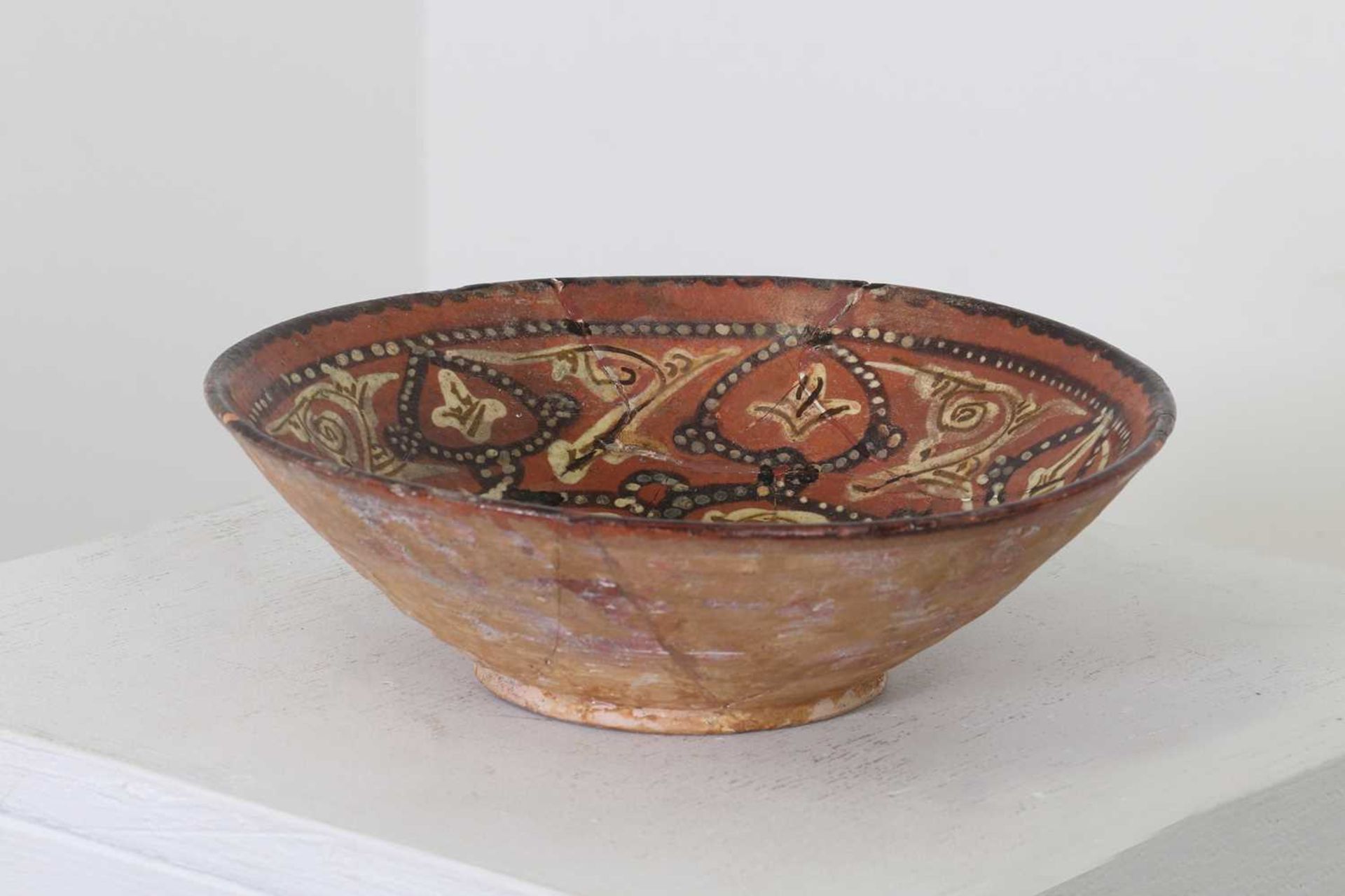 A Persian terracotta glazed bowl,