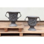 A pair of twin-handled lead urns,