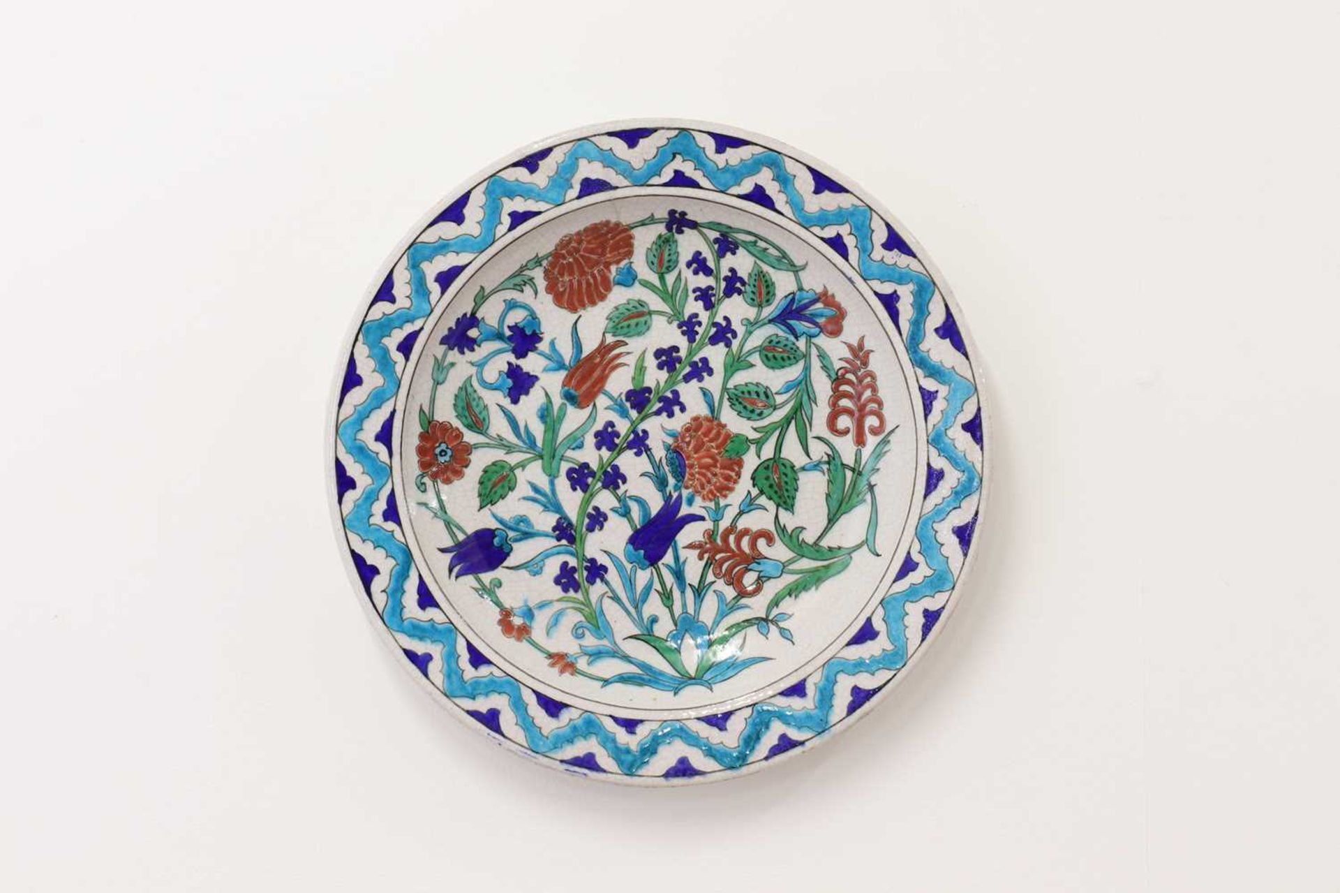 An Iznik-style pottery charger by Théodore Deck,