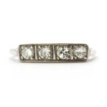 An Art Deco gold four stone diamond ring,