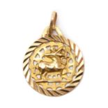 A gold zodiac pendant,