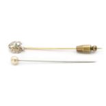 A gold emerald and diamond stick pin,