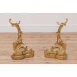 A pair of French rococo-style gilt brass chenet,