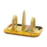 A Clarice Cliff 'Summerhouse' three-bar toast rack,