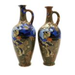 A near pair of Frederick Rhead Amstel pottery ewers,