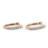 A pair of 9ct gold diamond half hoop earrings,