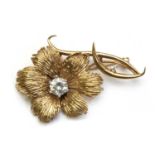 A 9ct gold cubic zirconia set flower brooch,