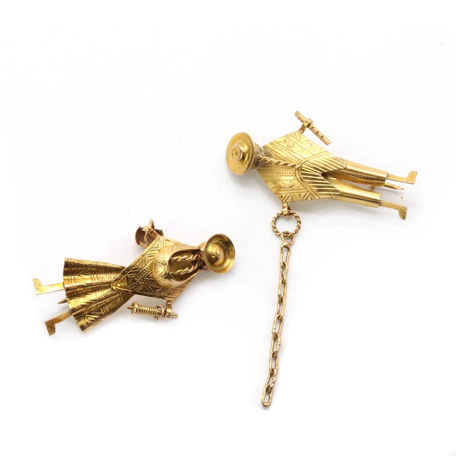 A pair of gold brooches,
