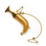 A gold dagger brooch,