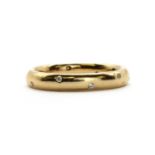 An 18ct gold diamond set wedding ring,