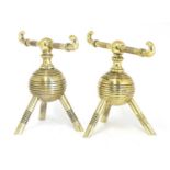 A pair of brass firedogs,