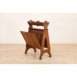 An Arts and Crafts oak book trough and folio stand,