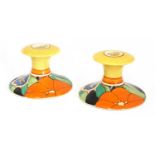 A pair of Clarice Cliff 'Red Gardenia' candlesticks,