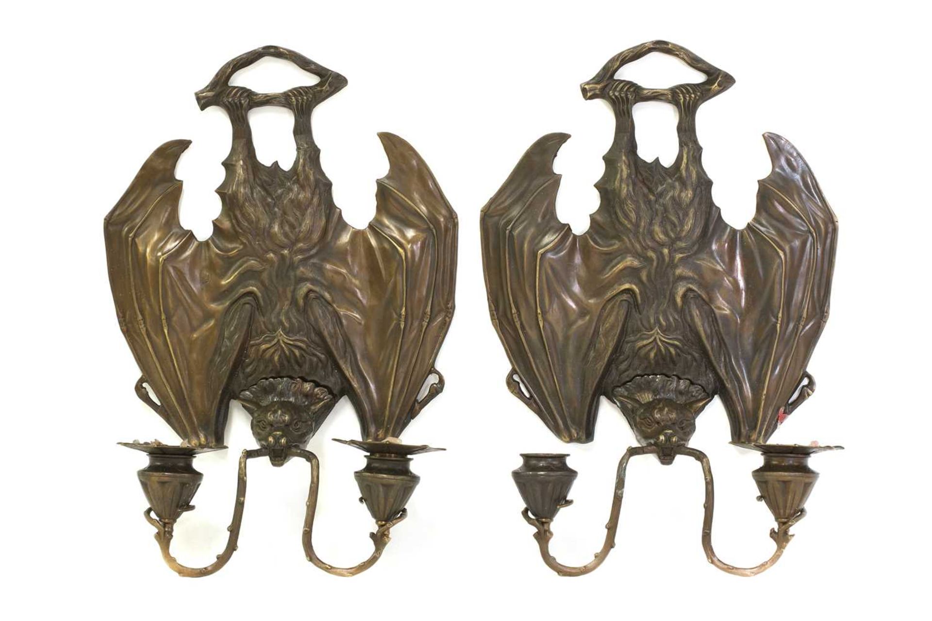 A pair of cast metal bat wall lights,