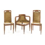 A pair of Austrian secessionist mahogany side chairs and a corner chair,