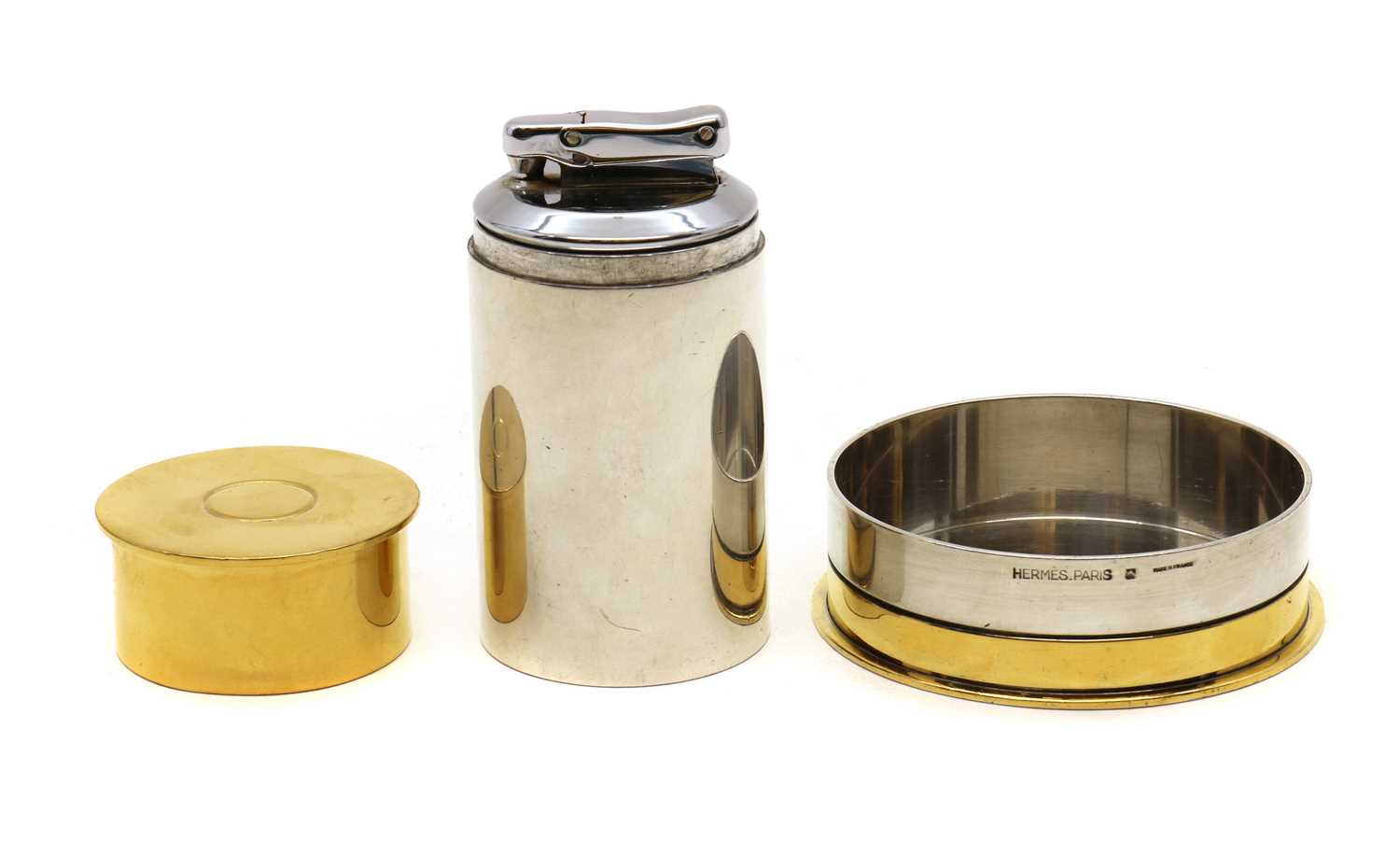 An Hermès silver and gold plated novelty table lighter,