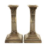 A pair of late Victorian silver candlesticks,